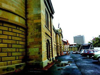 Vehicles on road along buildings