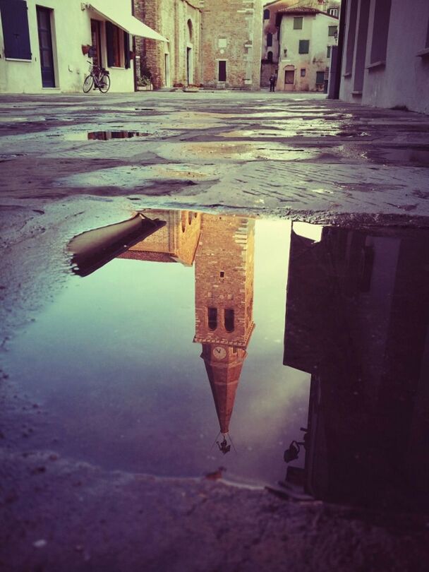 architecture, building exterior, built structure, puddle, building, reflection, water, residential building, residential structure, house, city, window, street, outdoors, day, no people, high angle view, wet, sky, waterfront