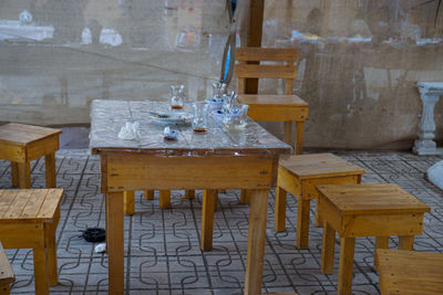 Close-up of chairs on table