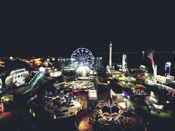 Illuminated ferris wheel at night