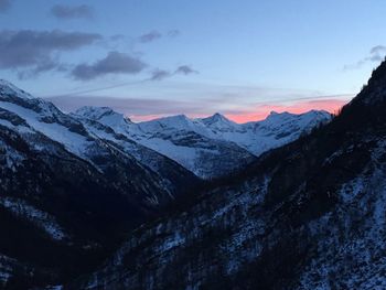 Scenic view of snowcapped mountains against sky during sunset