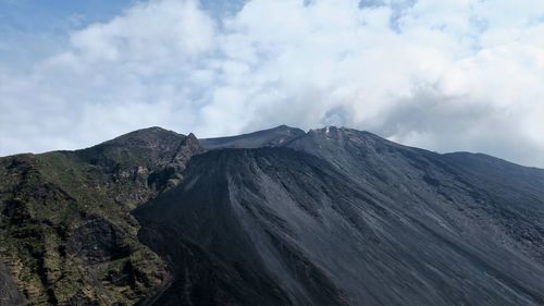 View of volcanic mountain against cloudy sky