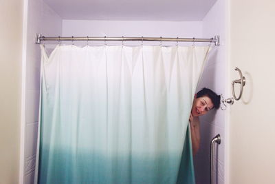 Portrait of young man standing on wall