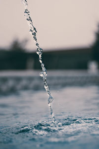 Close-up of frozen water against sky