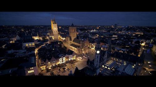 High angle view of city lit up at night