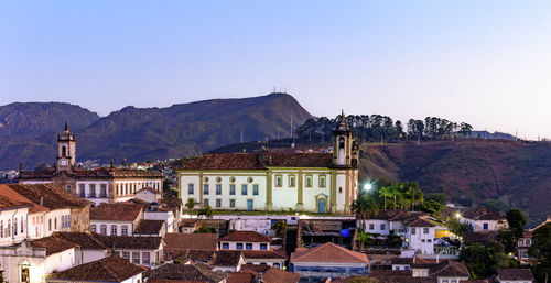 Houses in town against clear sky