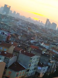 High angle view of buildings in city against sky during sunset