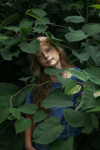 Portrait of a girl with green leaves