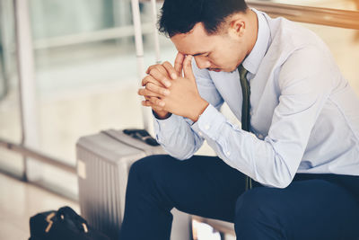 Stressed businessman sitting in airport