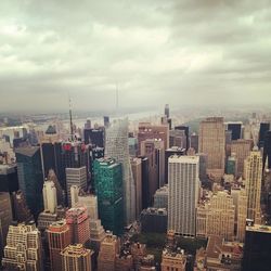 Cityscape against cloudy sky