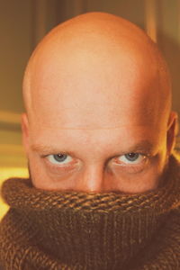 Close-up portrait of bald mid adult man wearing turtleneck