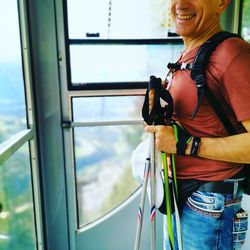 Portrait of smiling woman standing by window