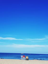 Scenic view of beach against blue sky
