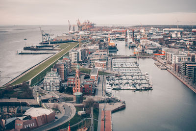 High angle view of commercial dock against sky in city