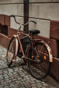 Bicycles on sidewalk against wall