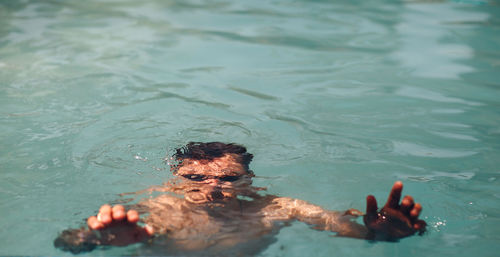 High angle view of man swimming in sea