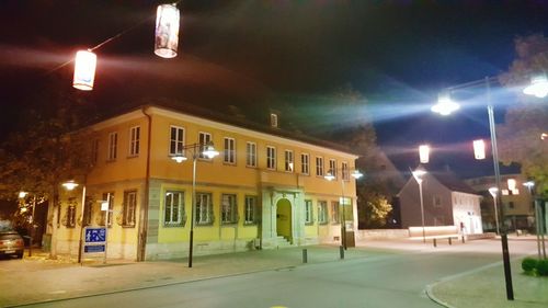 Illuminated street light in city at night