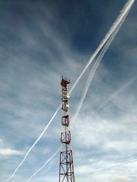 Low angle view of communications tower against sky