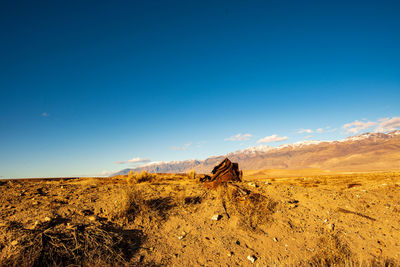 Scenic view of desert against blue sky