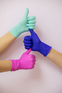 Low section of woman holding hands over white background