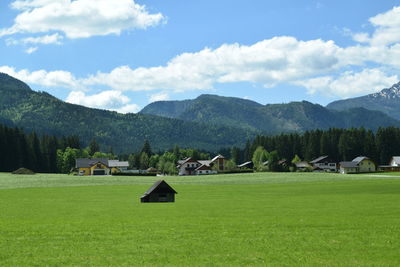 Scenic view of field and mountains against sky