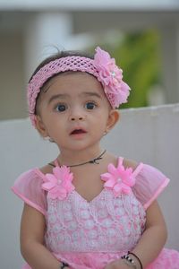 Portrait of cute girl with pink flower