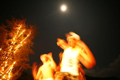 Low angle view of illuminated bonfire against sky at night