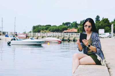 Portrait of young woman sitting in boat