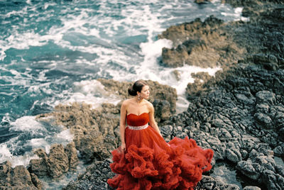 Rear view of woman standing on beach