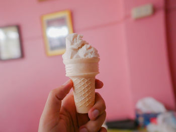 Close-up of hand holding ice cream cone