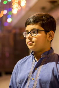 Boy wearing eyeglasses while looking away