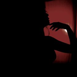 Silhouette woman standing in dark room