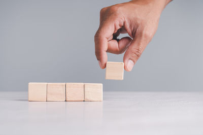Hand holding toy over white background