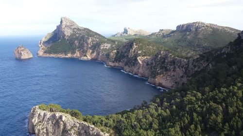 Scenic view of sea and mountains against sky