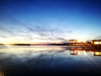 Scenic view of lake against sky at sunset