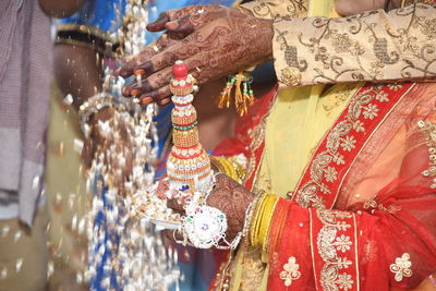 Midsection of bride and groom during wedding ceremony 