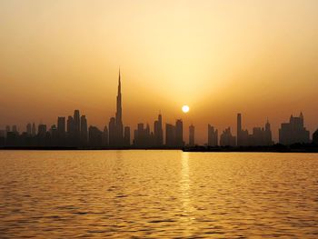 View of buildings in city during sunset