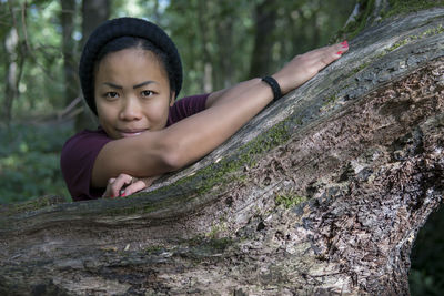 Portrait of girl on tree trunk