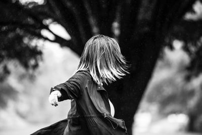 Girl tossing hair while standing outdoors