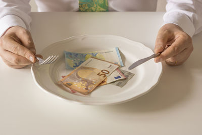 Close-up of hand holding food on table