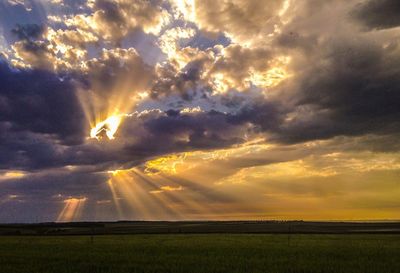 Scenic view of landscape against cloudy sky