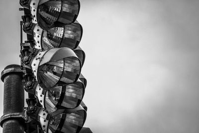 Low angle view of lighting equipment/lights against sky 