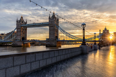 Tower bridge over thames river during sunset in city