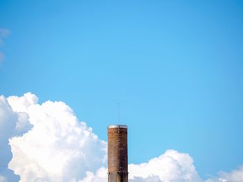 Low angle view of smoke stack against sky