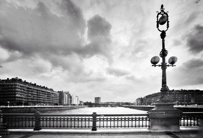 Bridge over river against buildings in city