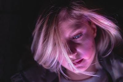 Close-up of young woman in darkroom