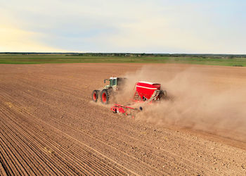 Tractor on field against sky