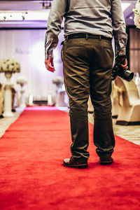 Low section of photographer standing on carpet at wedding ceremony