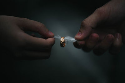 Close-up of hand holding cigarette