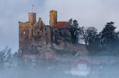 Old building against sky during winter